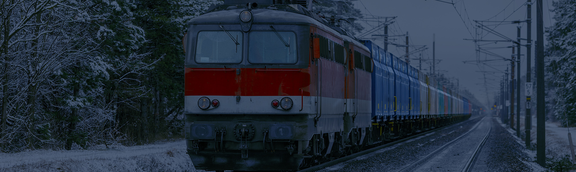 A,Powerful,Locomotive,Pulls,A,Freight,Train,Against,The,Backdrop